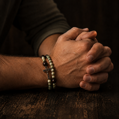 Praying hands with a bracelet on a wooden surface